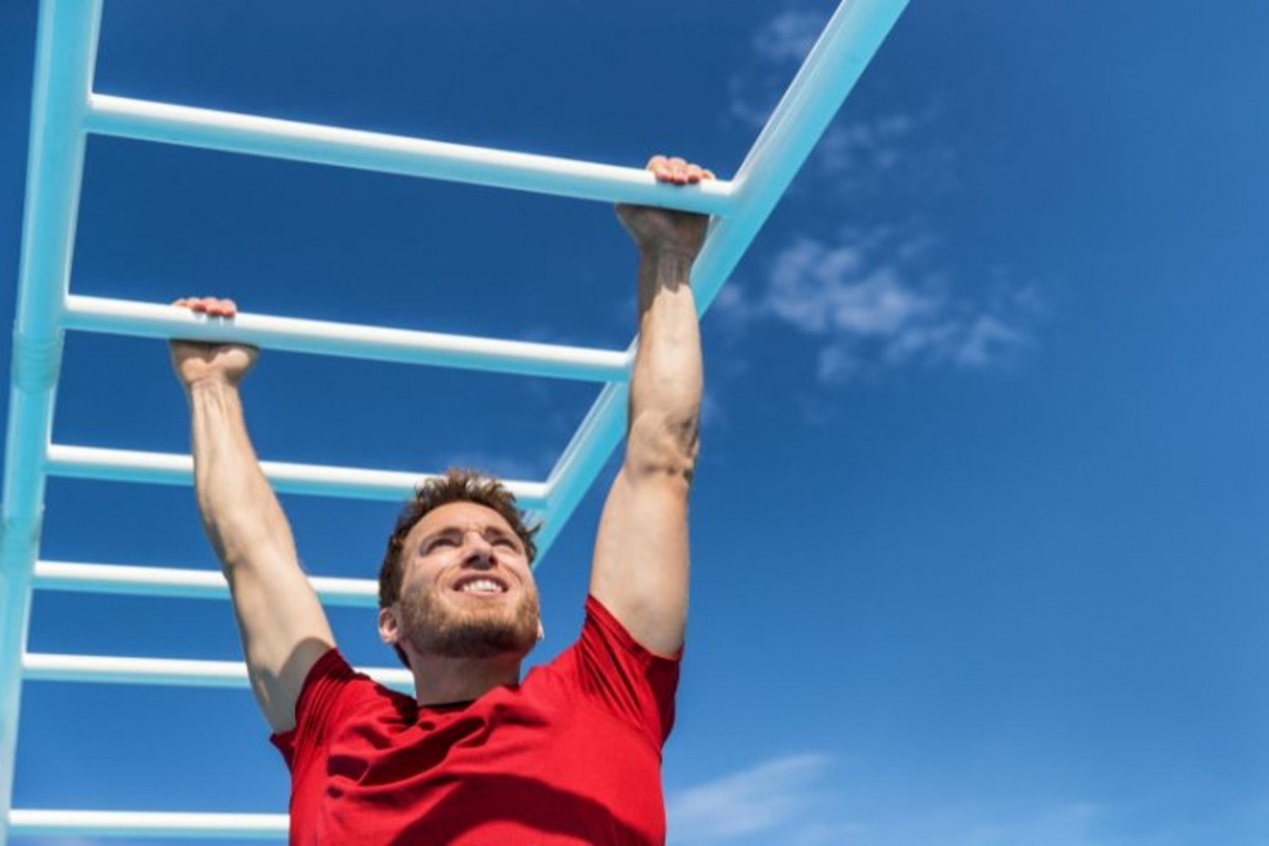 guy playing in monkey bars.jpg